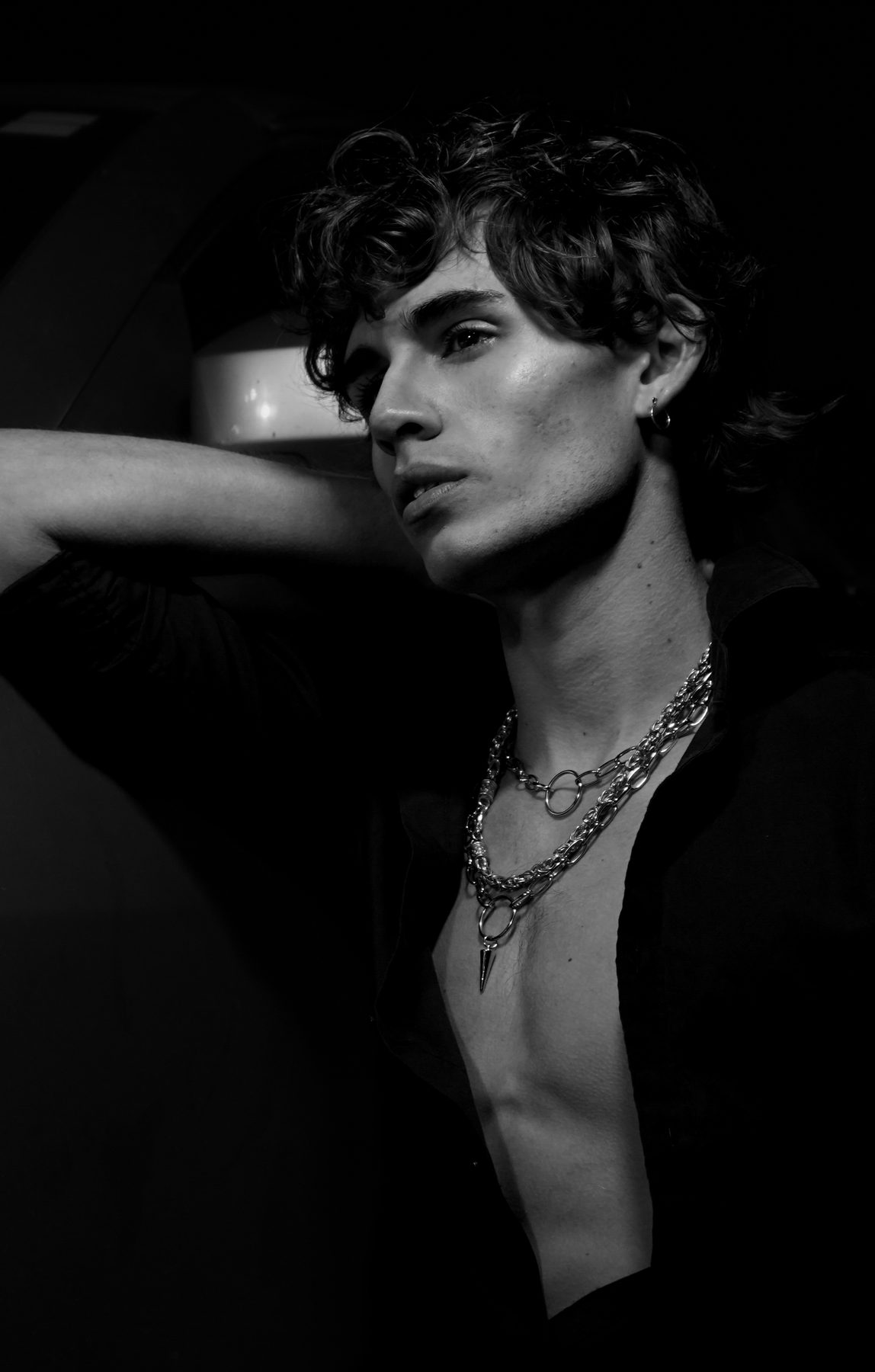 Antonius, black and white portrait with layered chain necklaces